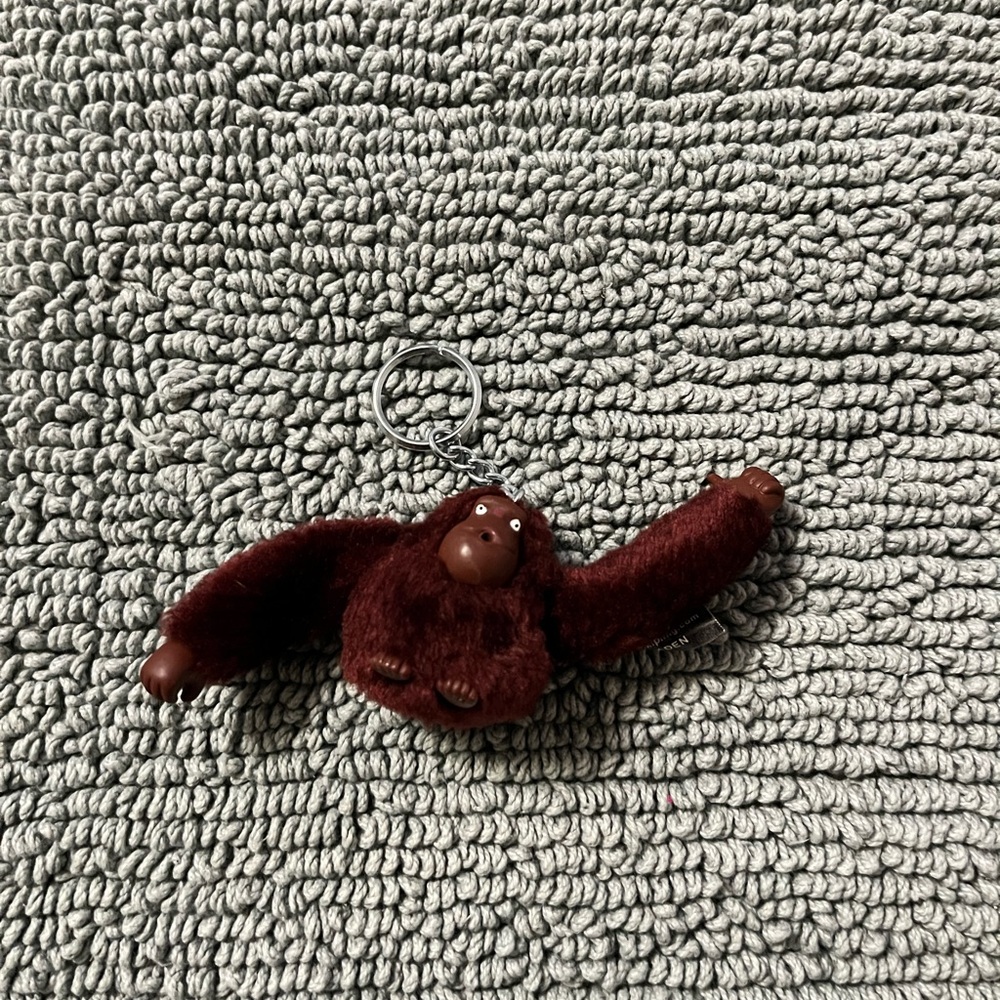 Kipling Plush Monkey Keychain 
Color: Burgundy Name: Jaden